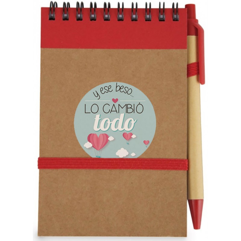 Libreta roja con bolígrafo rojo y adhesivo frase