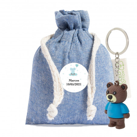 Llavero en forma de oso presentado en bolsita de tela con adhesivo personalizable de bautizo