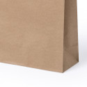 Neceser de yute en bolsa de kraft con adhesivo personalizado